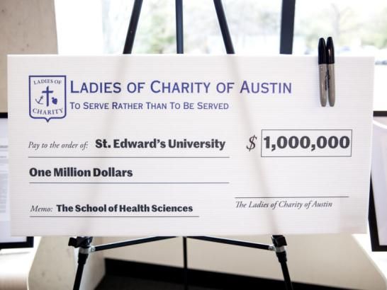 The Ladies of Charity of Austin check signing presentation in the Munday Library.