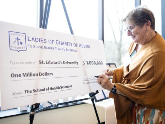 The Ladies of Charity of Austin check signing presentation in the Munday Library.