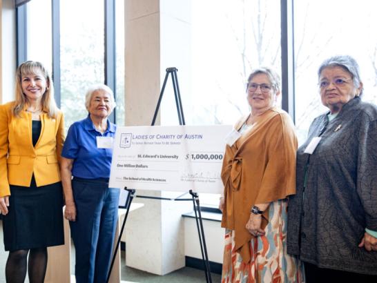 The Ladies of Charity of Austin check signing presentation in the Munday Library.