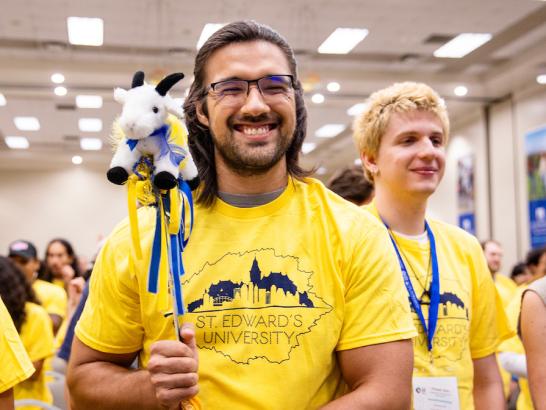 Transfer students wear matching yellow shirts and participate in an orientation activity.