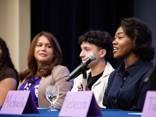 A group of students speak on a panel.
