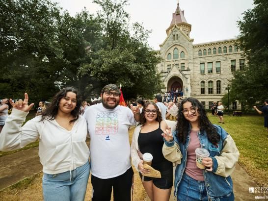 Students celebrating Homecoming in front of main building