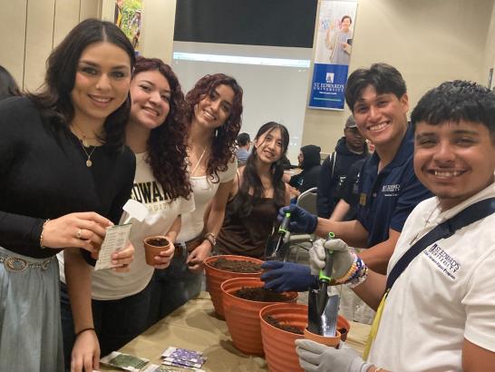 CAMP students working on potting plants for an event