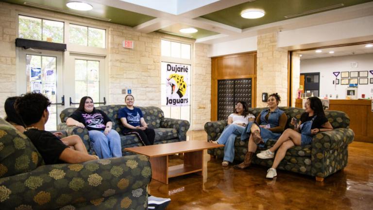 Students conversing in the lobby of Jacques Dujarié Hall.