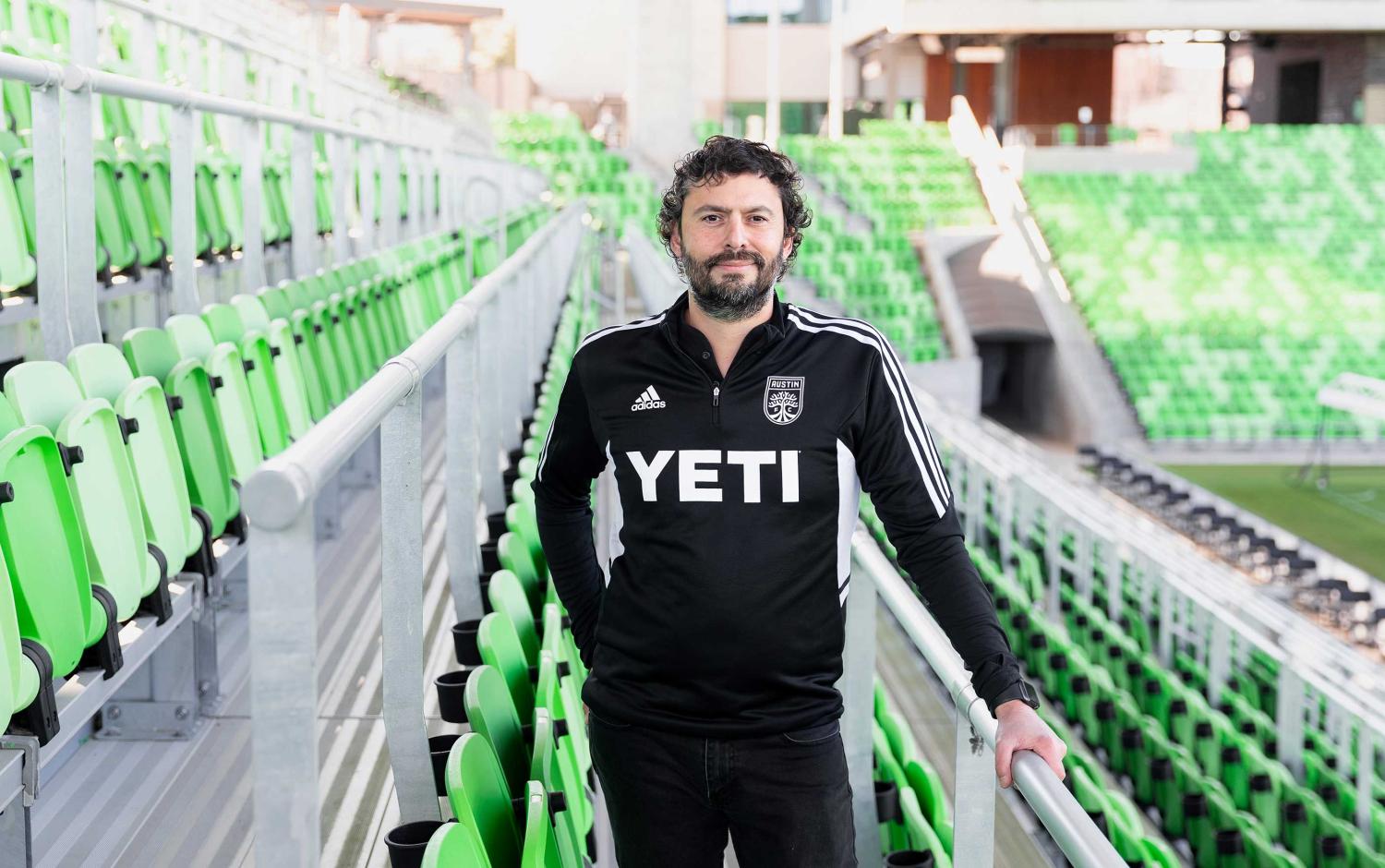 Alfredo Naim standing in Q2 Stadium for Austin FC and smiling