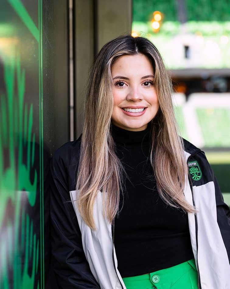 Emely Alvarado standing and smiling