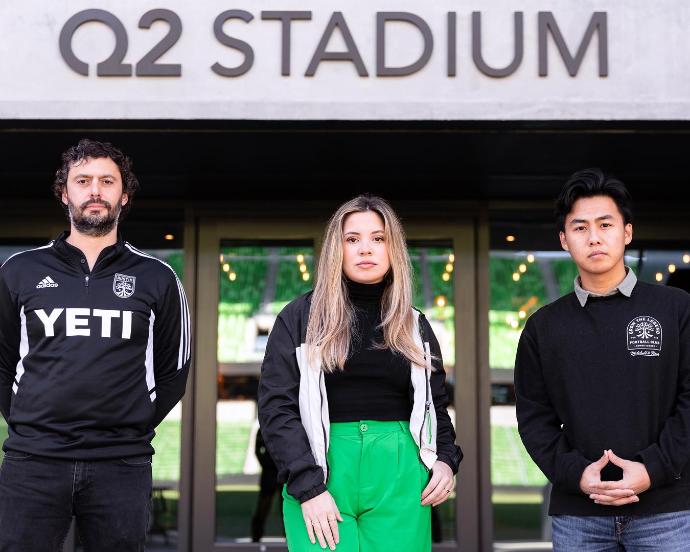 St. Edward's students and alumni pose in front of Q2 Stadium