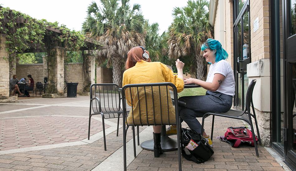 triston and riley sitting outside of jo's coffee shop