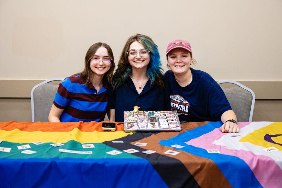Students engaging in LGBTQIA+ discussions at a campus event.