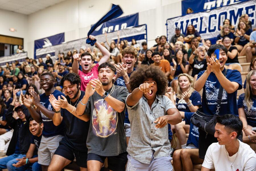 Students cheering in the stands at the pep rally during Anchors Weekend.