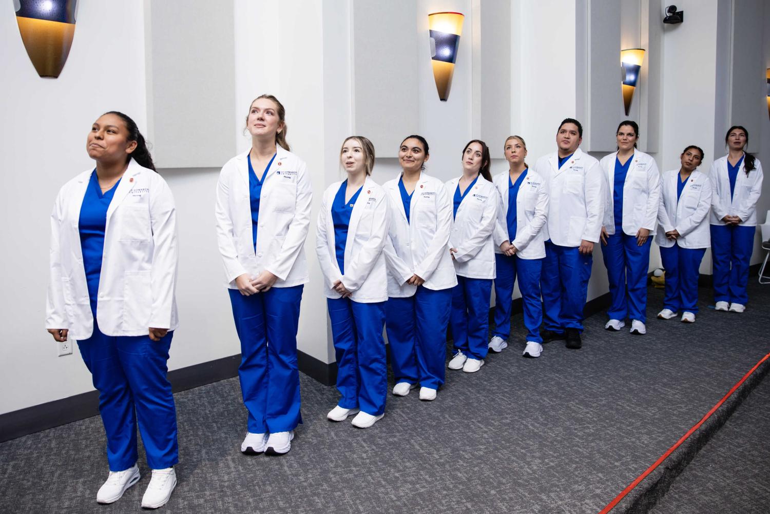 Nursing students take their Pledge of Dedication at the first-ever White Coat ceremony at St. Edward's.