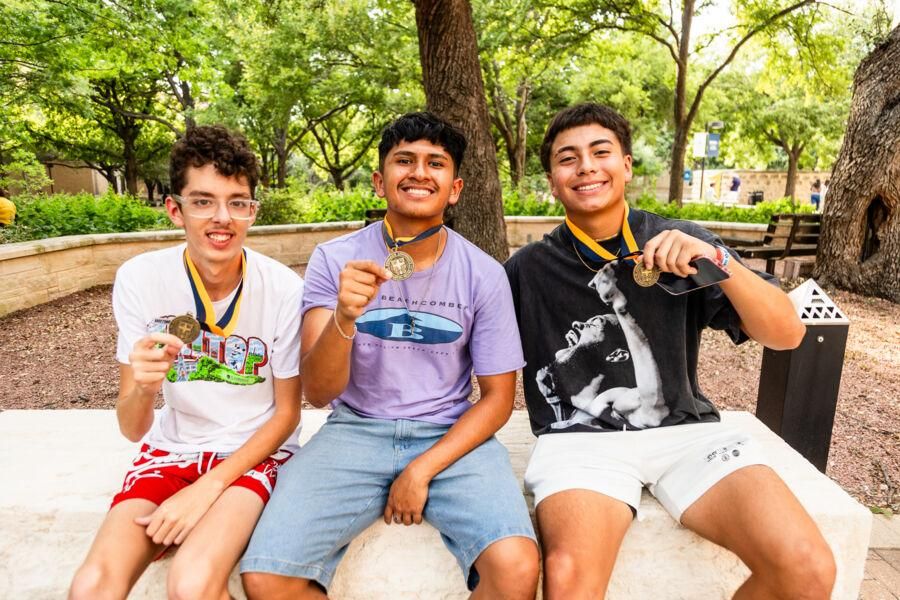 New students posing for a photo with their Medallions during the Legacy Walk.