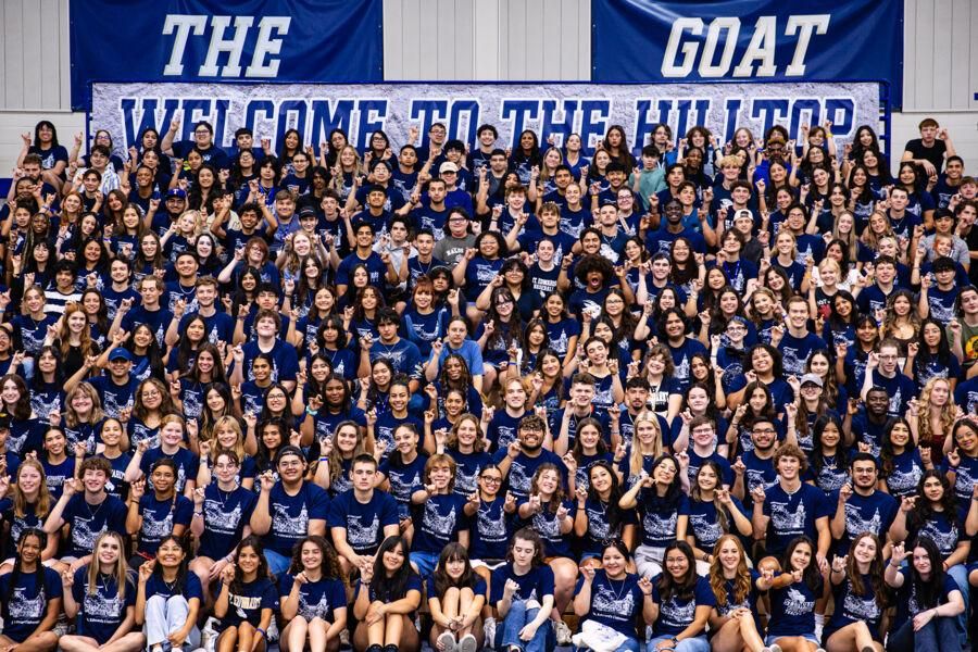 Freshman posing for a class of 2028 group photo on the bleachers.