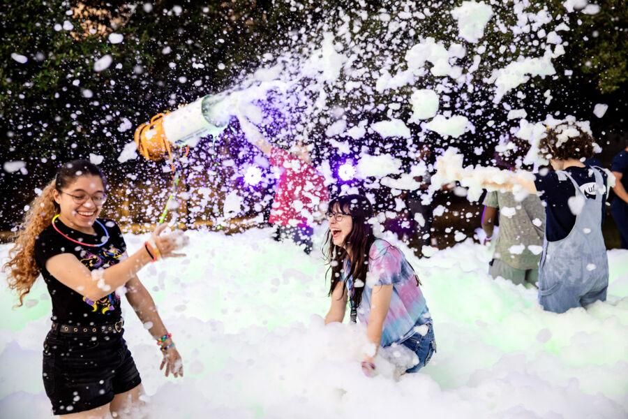 Students having fun at a foam party near Main Building during Anchors.