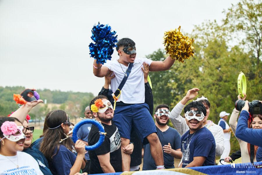 Students cheering during the Homecoming 2024 parade.