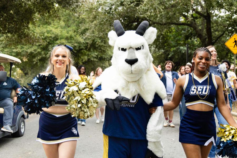 Cheerleaders posing with the St. Edward's mascot during Homecoming 2024.