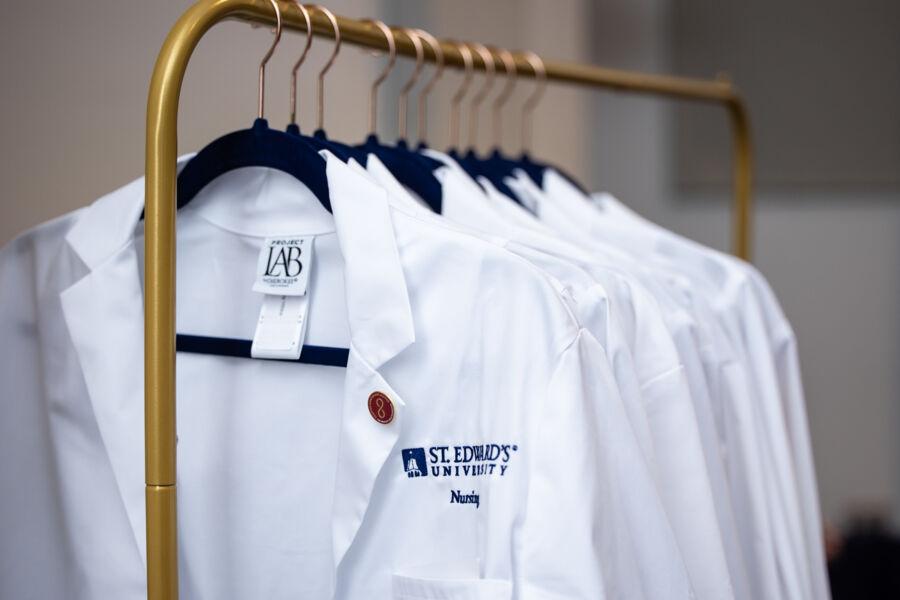 White coats distributed to nursing students at the White Coat Ceremony.