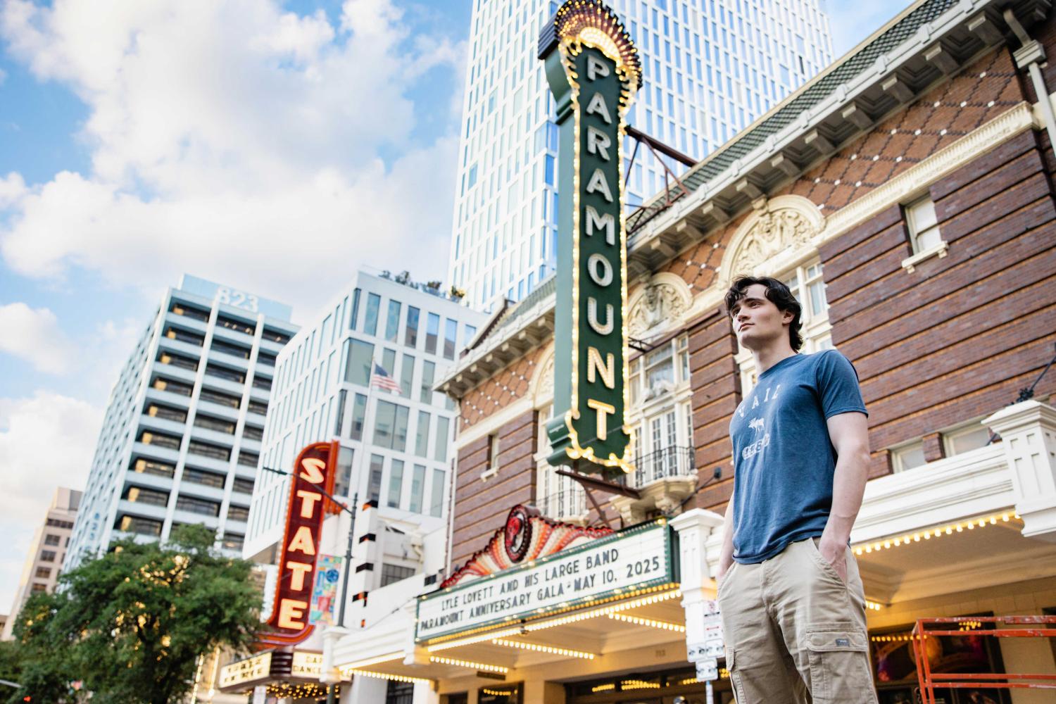 Sam McFarland poses in front of the Paramount Theater in downtown Austin