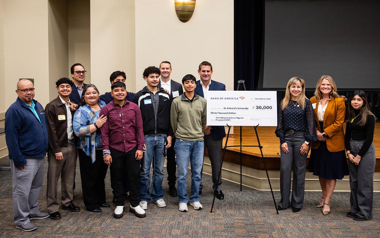 President Montserrat Fuentes, donors and students celebrate a check presentation during First-Gen Breakfast.