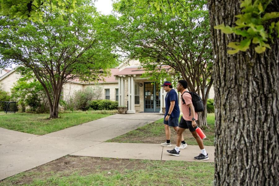 Students walking in front of Community Building 1.