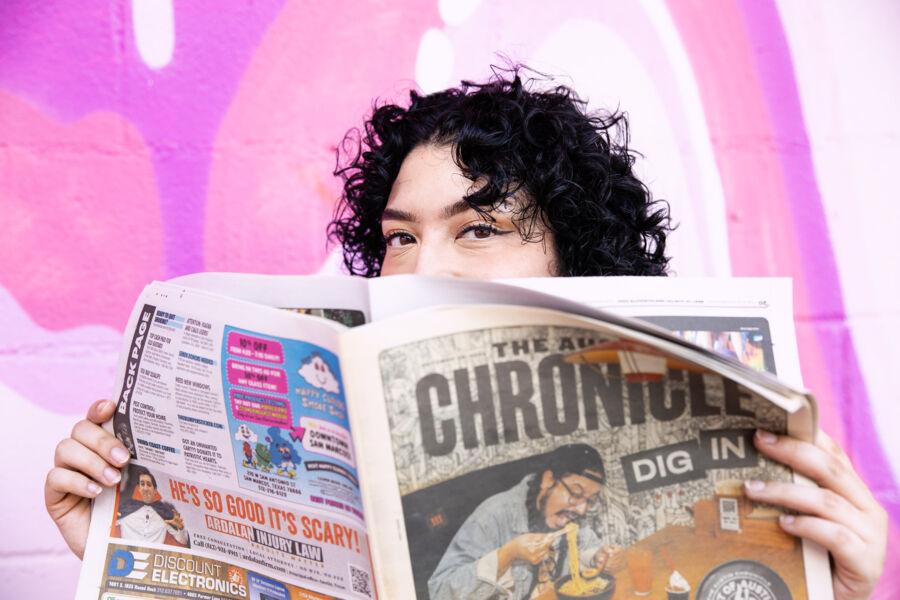 Fabiana Melendez poses with an Austin Chronicle newspaper