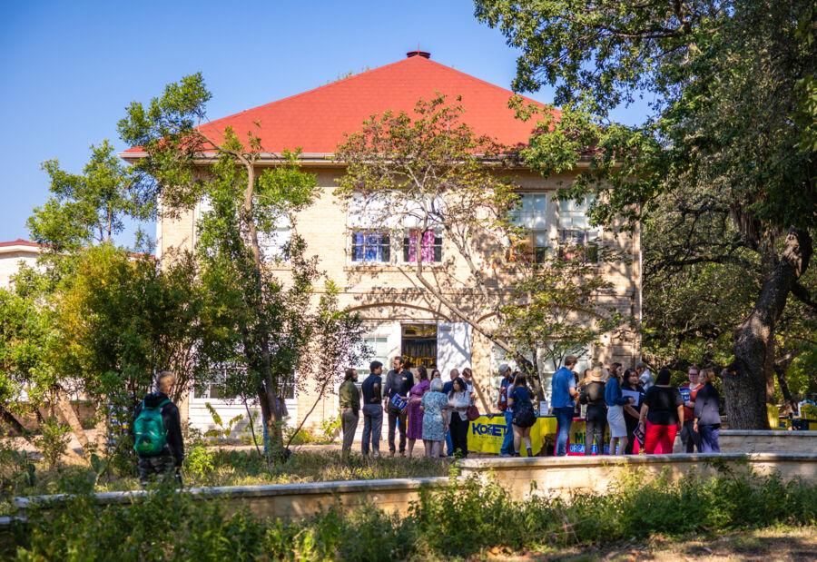 Hilltoppers and supporters gather in front of the Carriage House to celebrate the grand opening of the reimagined space for The Kozmetsky Center.