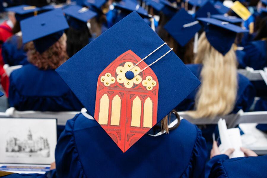 Red Doors design on student's cap during December Commencement.