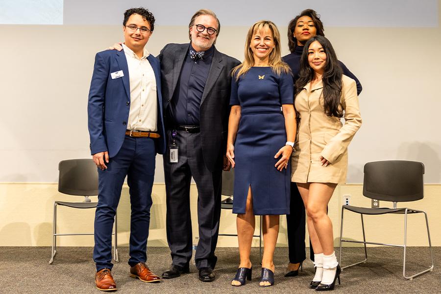President Montserrat Fuentes joins the chancellor of Austin Community College and three transfer students for a group photo.