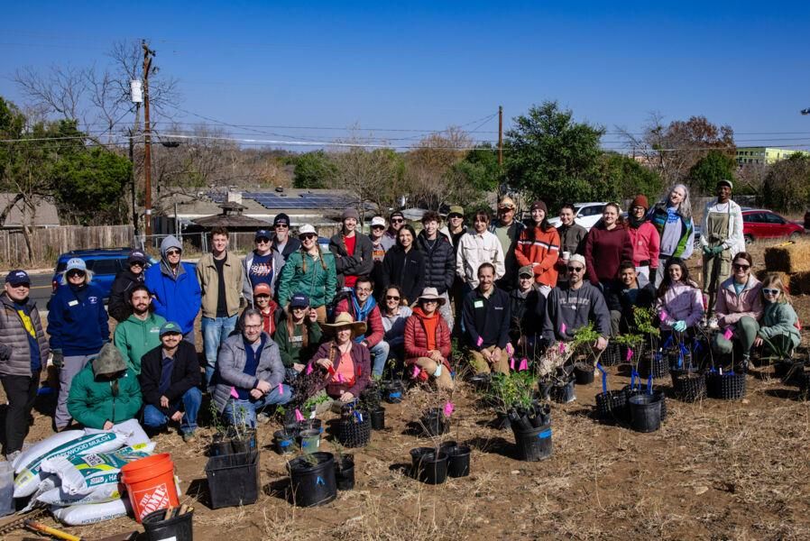 Hilltoppers planting trees and shrubs at the first-ever Tiny Forest in Austin, which is located at St. Edward's.