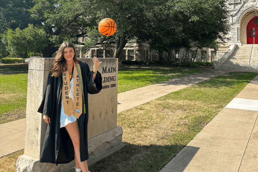 Matilda Soric poses with a basketball after graduation in front of Main Building