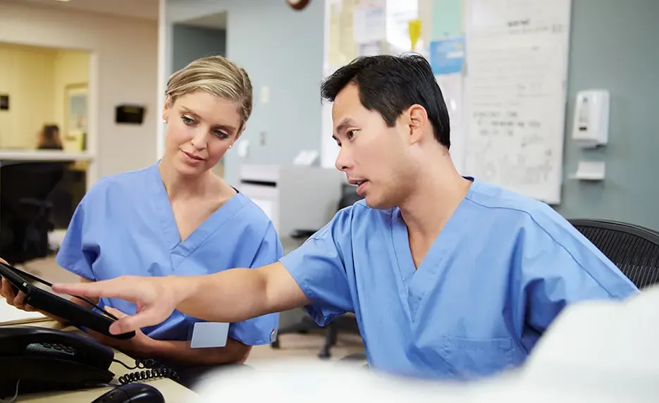 Clinical medical assistants working together in medical office