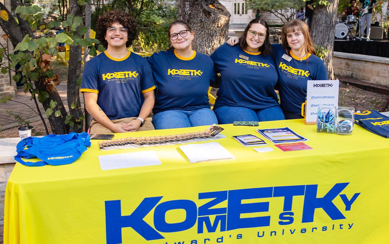 Students posing for a photo at a Kozmetsky event on campus.