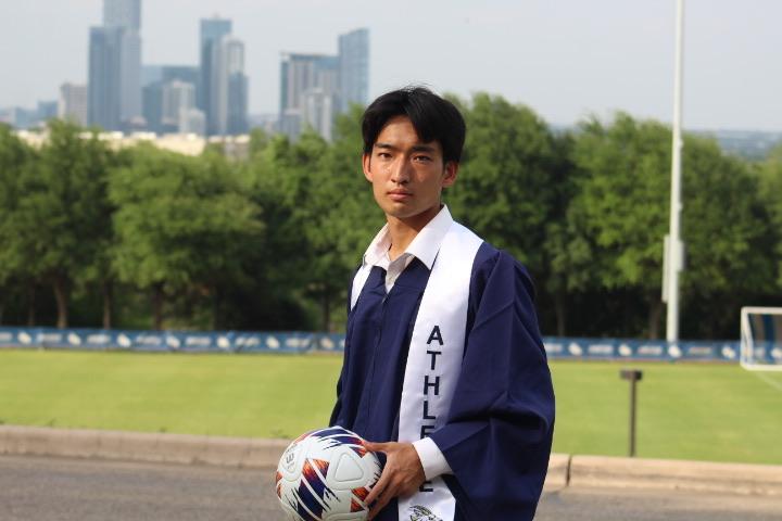 Shunji Watanabe poses for an undergraduate photoshoot on the soccer field. 
