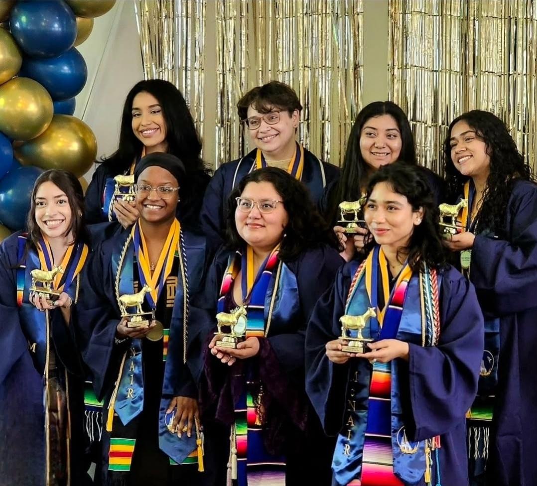 Rivera poses with her McNair Scholars Cohort, holding a goat trophy that says "Most Likely to Present at the UN."