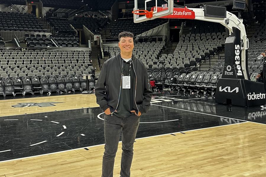Gabe Garza '22 poses at the Frost Bank Center in San Antonio, home of the Spurs.