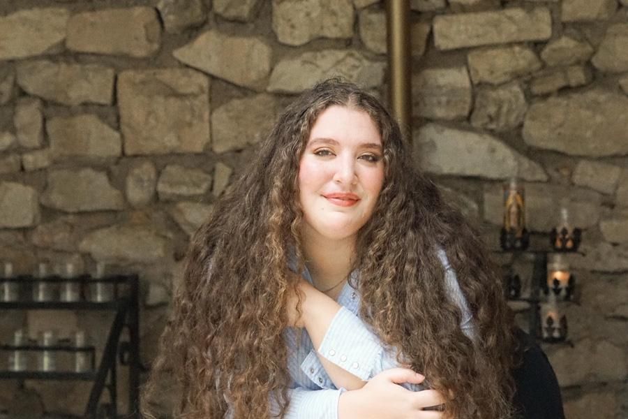 Kelly Salinas' 22 poses at Our Lady of Lourdes Grotto on campus.